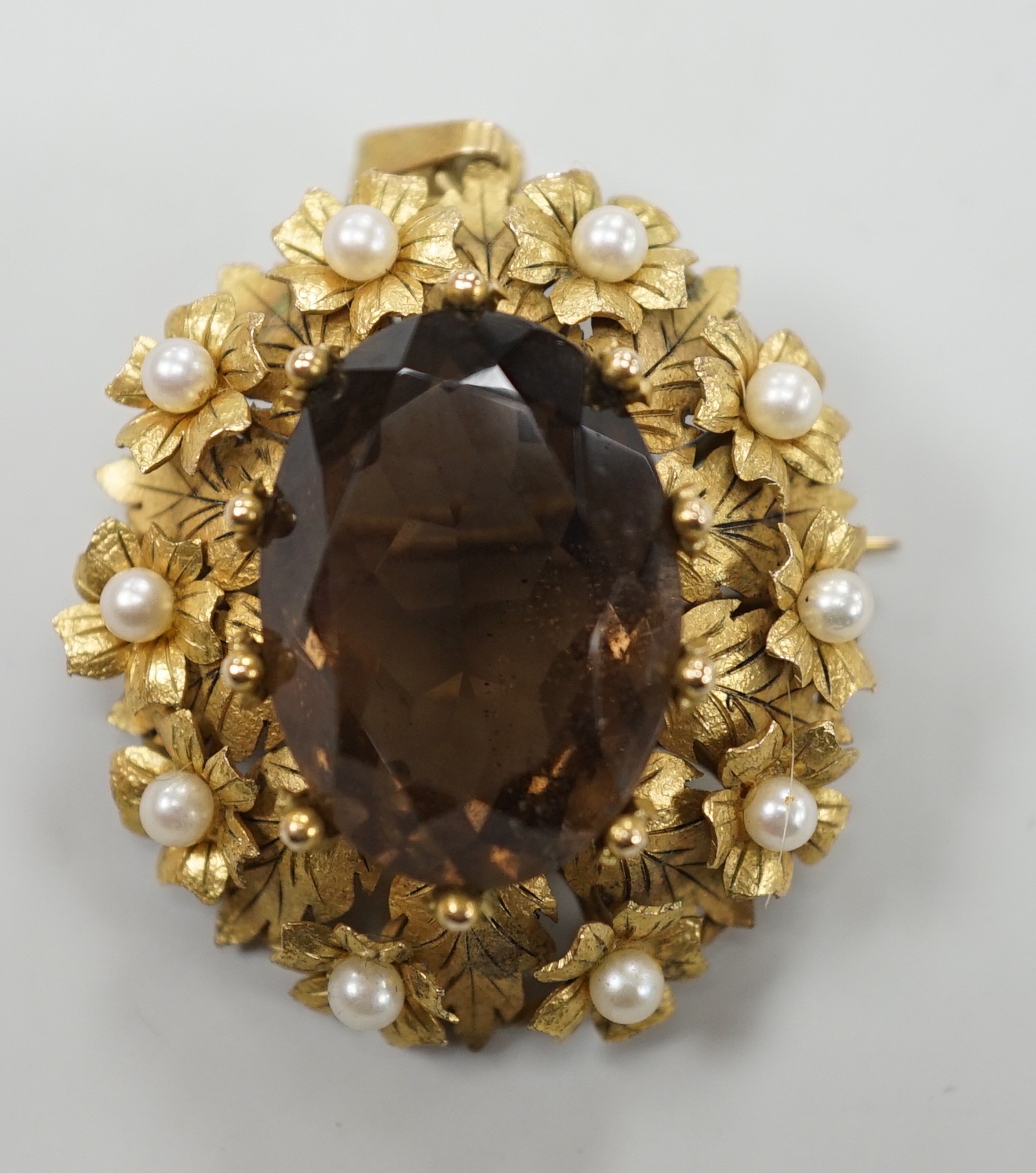 A yellow metal, oval cut brown quartz and cultured pearl set pendant brooch, 34mm, gross weight 12.8 grams.